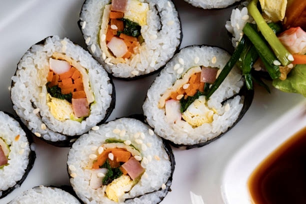 Korea Gimbap or Kimbap which has pickled root vegetables (carrots) and spinach and eggs