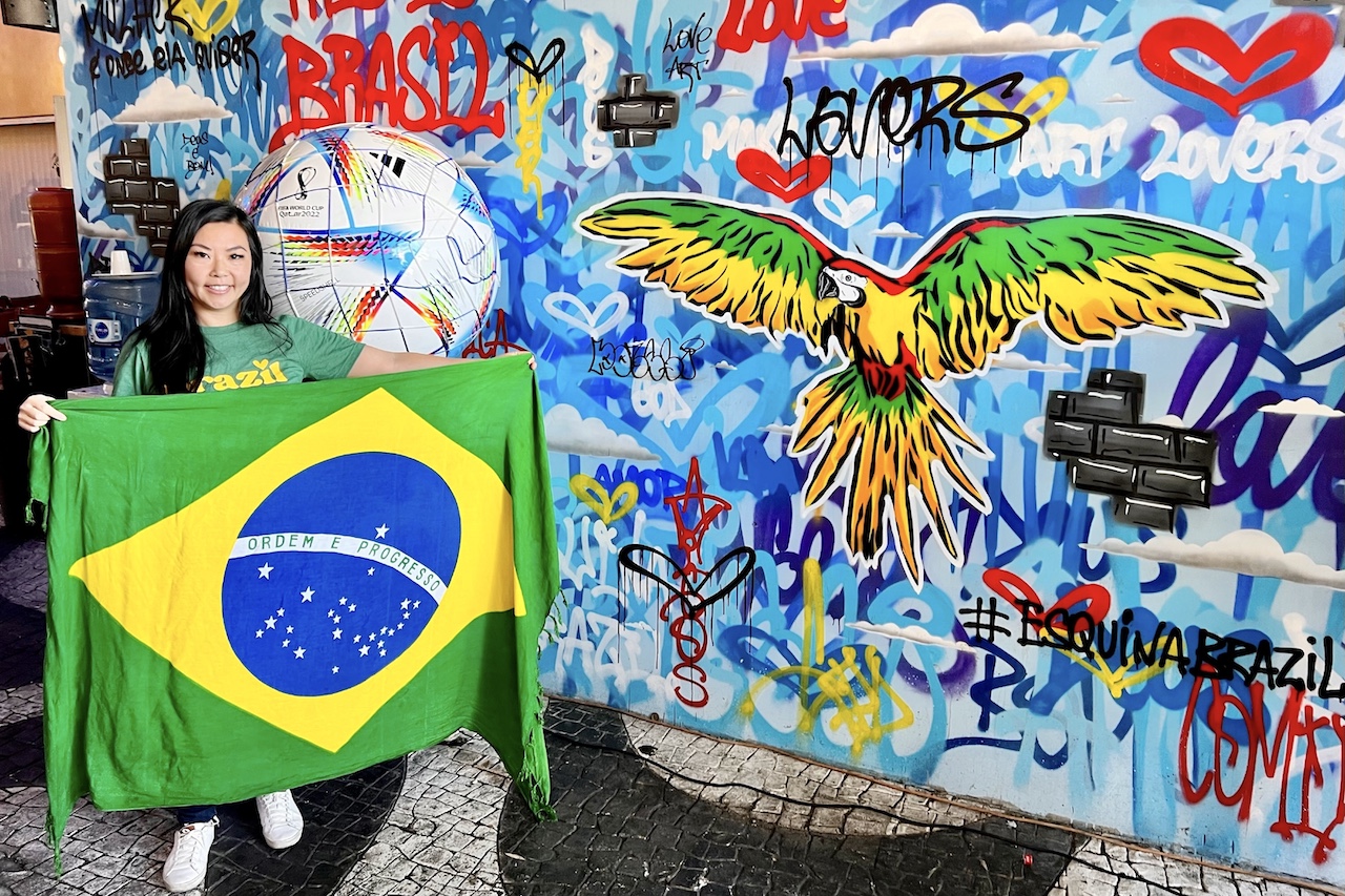 Tinger is holding a Brazilan flag in preparation for a World Cup watch party event